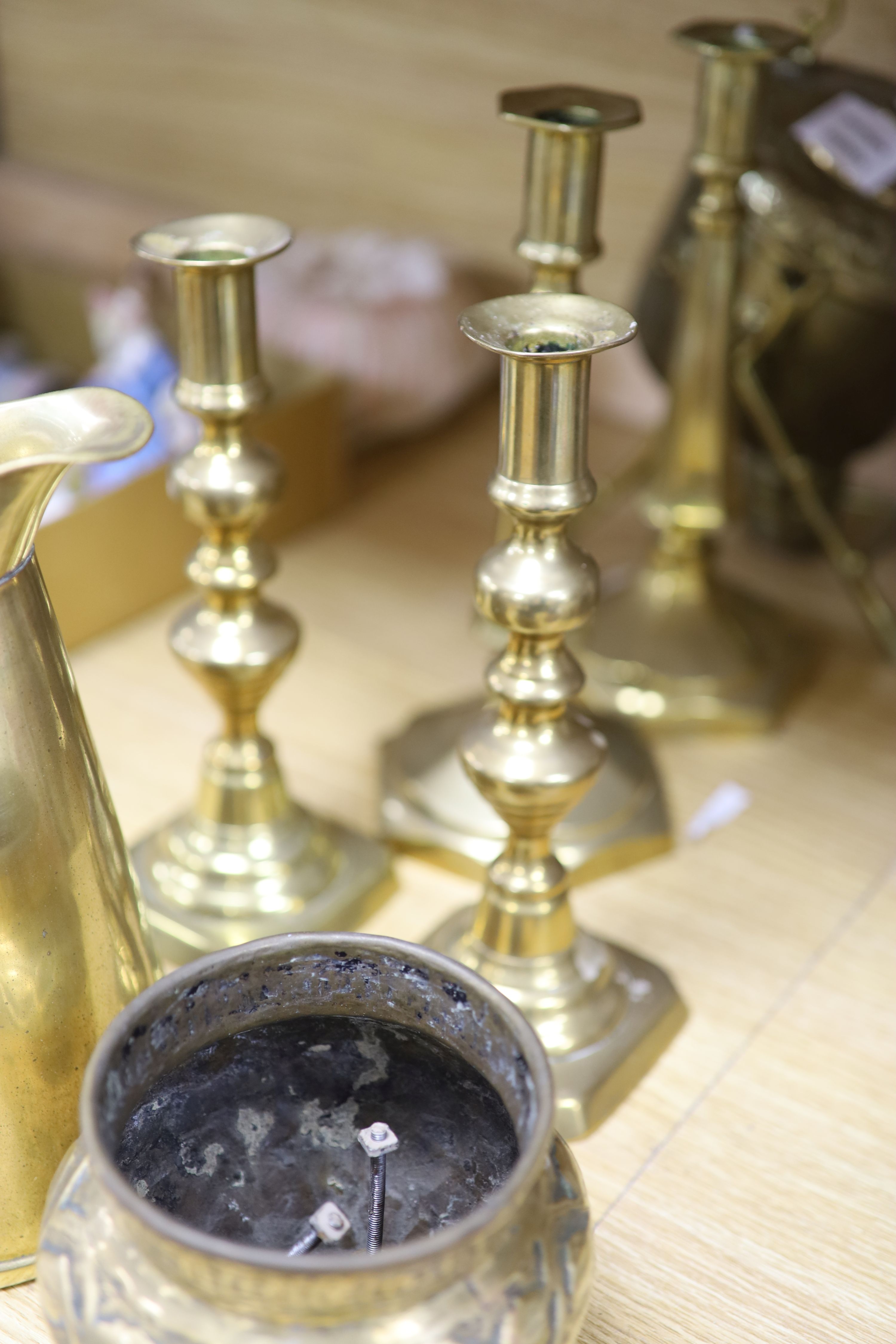 A Victorian brass spirit kettle on stand, two pairs of brass candlesticks and a jug